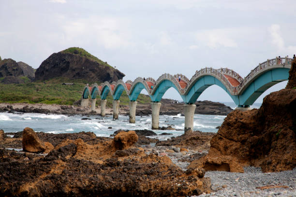 Taitung, Taiwan - November 16, 2014: Visitors walk across the Sansiantai Dragon Bridge to Sanxiantai Island, Taitung, Taiwan