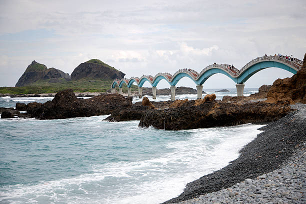 Taitung, Taiwan - November 16, 2014: Visitors walk across the Sansiantai Dragon Bridge to Sanxiantai Island, Taitung, Taiwan