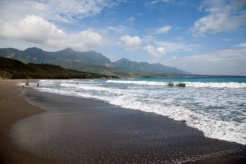 Taitung, Taiwan- November 16, 2014: Tourists visit a beach on the Eastern Taiwanese coastline, waves against the shore, Taiwan