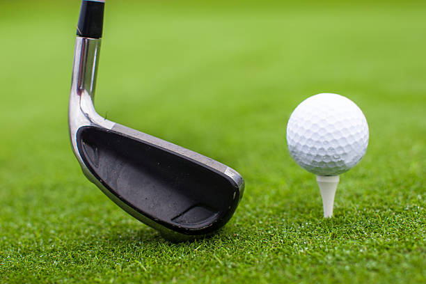 istock Golf tee ball club driver in green grass course closeup 467130847
