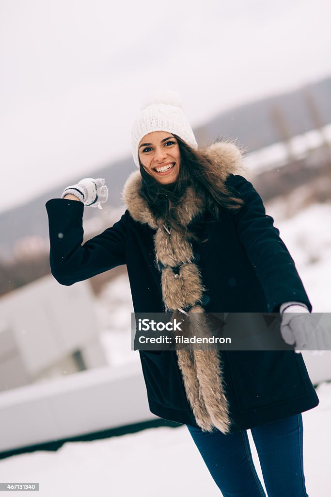 Winter portrait A beautiful girl throwing a snowball 20-24 Years Stock Photo