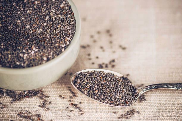 orgánico semillas de chia en tazón con cucharadita. superfoods. alimentación saludable. - chia seed spoon food fotografías e imágenes de stock