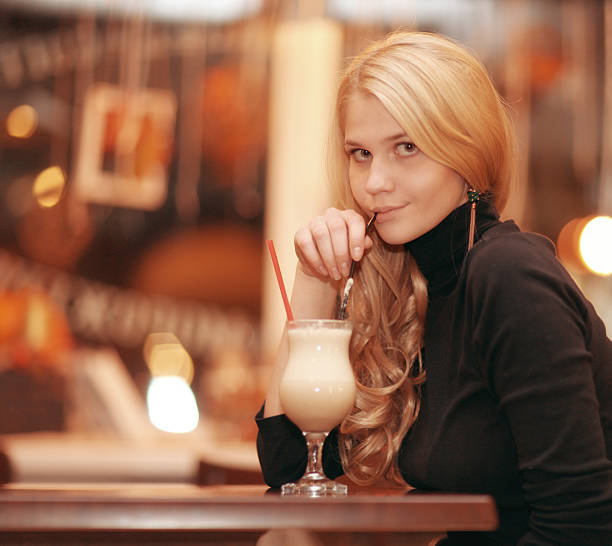 istock cheerful girl drinking coffee in a cafe at night 467135164