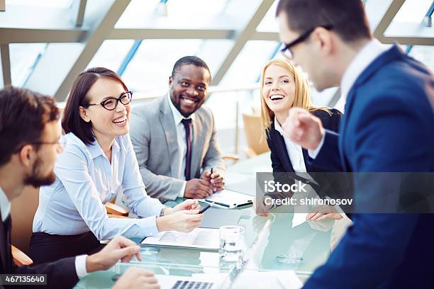 A Cheerful Discussion Between Businesspeople Stock Photo - Download Image Now - 2015, Adult, Business