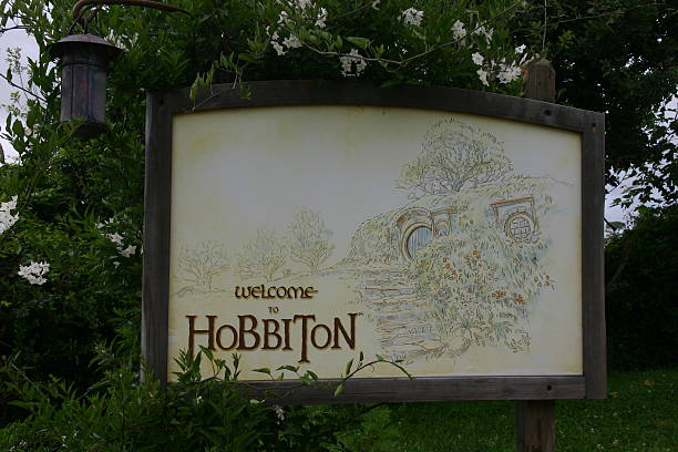 Welcome Sign at Hobbiton Matamata, New Zealand- January 7, 2015: welcome sign outside the entrance to Hobbiton. Hobbiton is a movie set that was used in the filming of the Lord of the Rings movies and The Hobbit movies.  matamata new zealand stock pictures, royalty-free photos & images