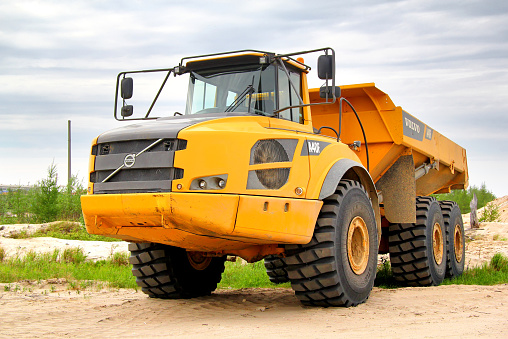 Novyy Urengoy, Russia - June 24, 2014: Yellow Volvo A40F articulated dump truck parked at the city street.