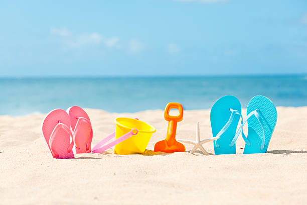 estate vacanza in spiaggia con flip-flop e giocattoli - lui e lei foto e immagini stock