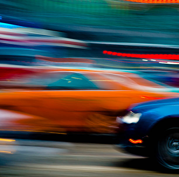 Two cars in blurred motion ( Panning left)