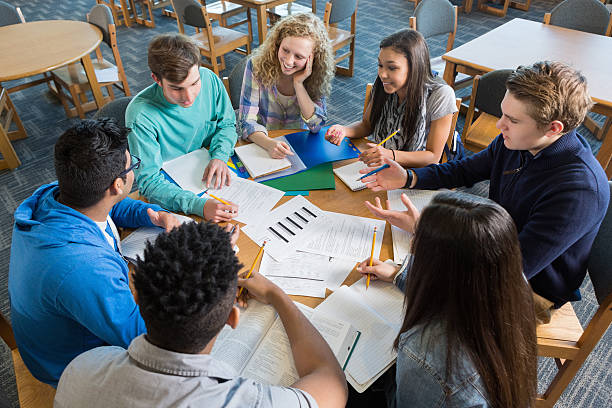 istock Large diverse group of students studying together in library 467142812