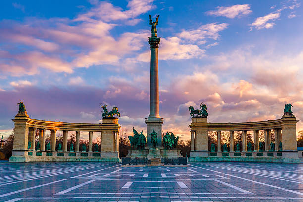 Heroe's Square, Budapest Heroes Square Budapest in morning. The square is the end of Andrassy Avenue, this street is part of Unesco World Heritage. This photo was made after a rain, the reflection is real, not composit image. budapest stock pictures, royalty-free photos & images