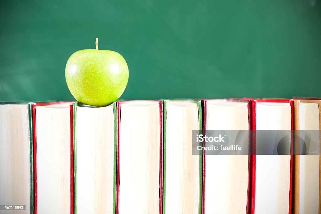 Back to school:Green apple sitting on education books 2015 Stock Photo