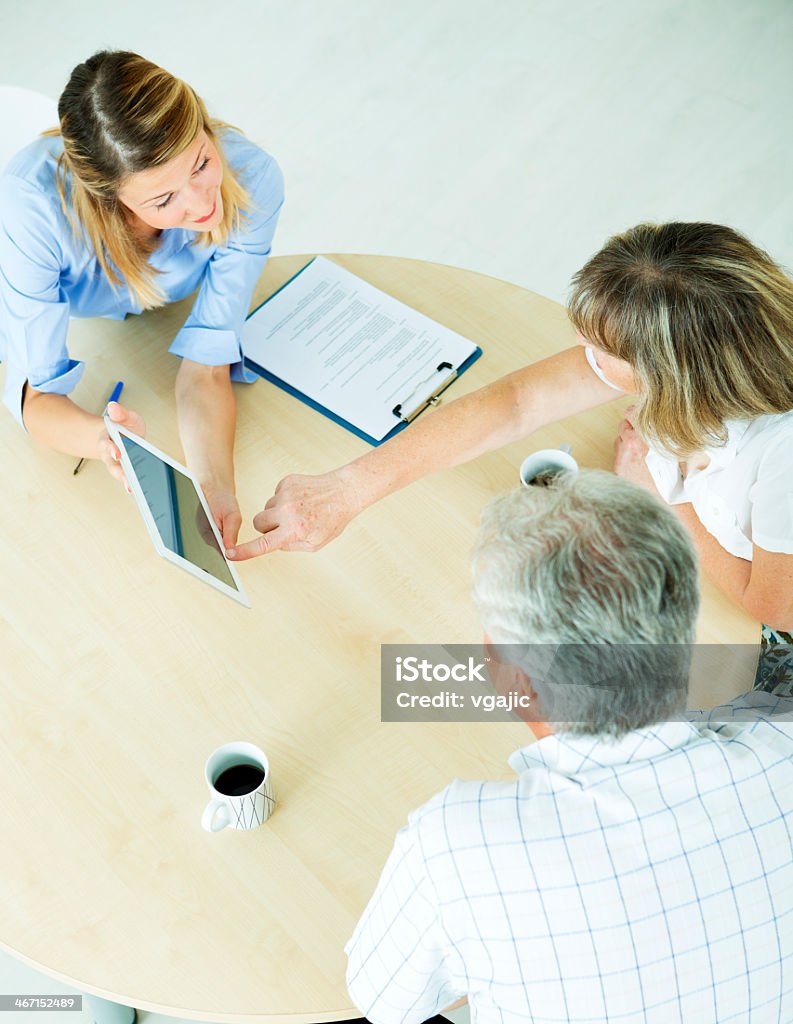 Senior Couple Meeting with Financial advisor. Senior couple meeting with financial advisor and talking about insurance and retirement options. Office or bank indoors. Home Interior Stock Photo