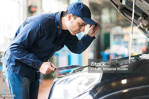 Mechanic Working In His Workshop Stock Photo - Download Image Now - 2015, Adult, Adults Only