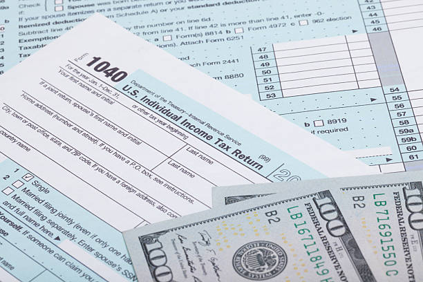 istock US Tax Form and dollars - studio shot 467152964