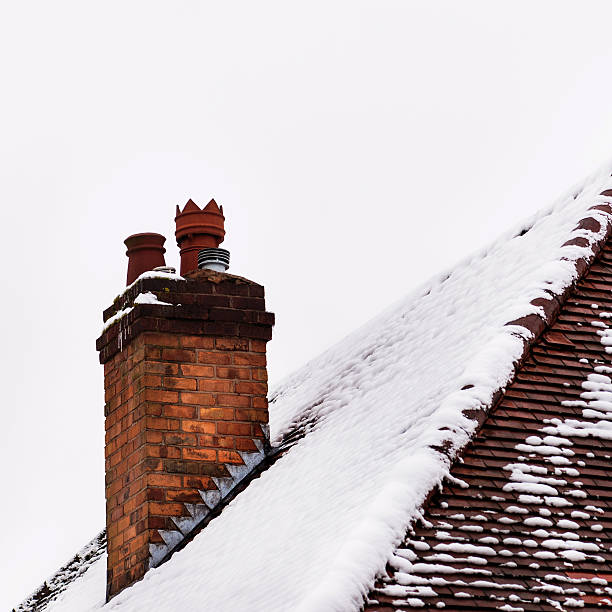istock Old house clay brick chimney in winter covered with snow 467153736