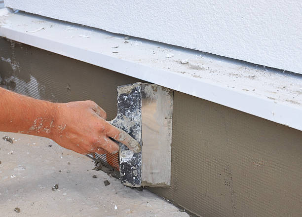 istock Man's hand plastering a wall with trowel. Construction worker. 467156278