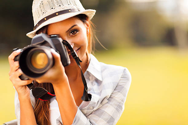 istock attractive young woman taking pictures 467157685