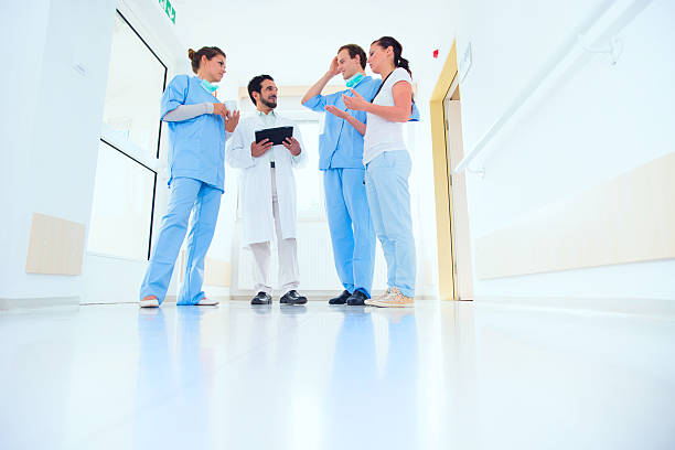 istock Doctors and nurse talking in hospital corridor 467158671