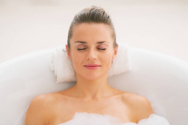 istock young woman relaxing in bathtub 467159721