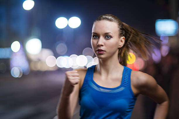 istock A young woman jogging at night 467159818