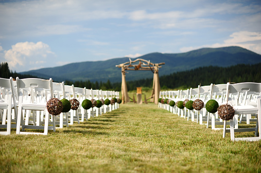 Rustic wedding ceremony site with mountains in the background. 