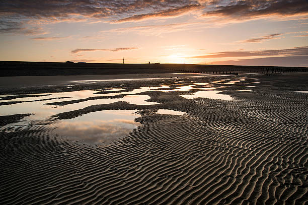 istock Vibrant sunrise landscape reflected in low tide water on beach 467162605