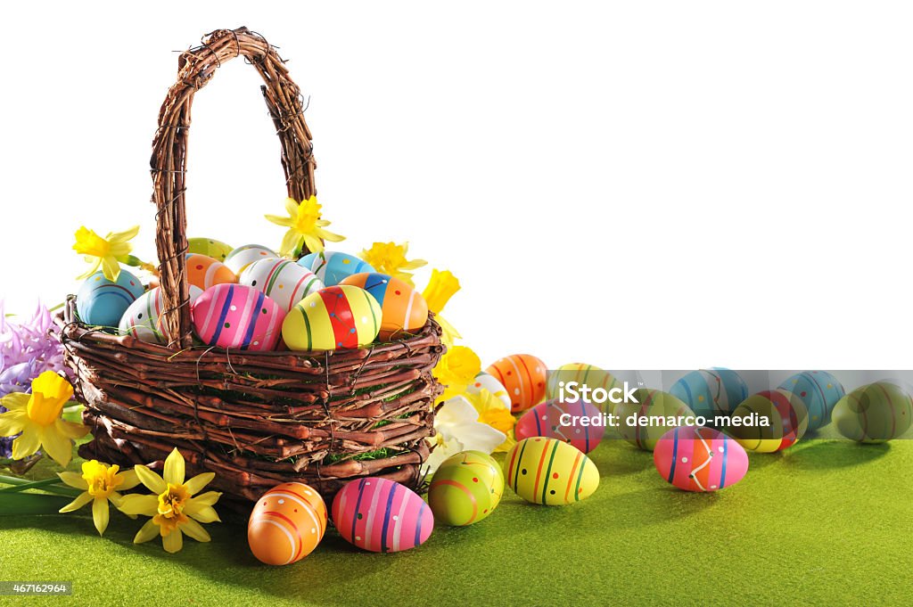 colorful easter eggs colorful easter eggs and narcissus in easter nest on grass 2015 Stock Photo