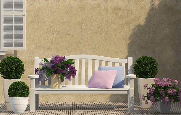 white bench and spring lilac flowers