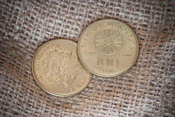 100 drachmen-griechische münzen - white currency remote shiny stock-fotos und bilder