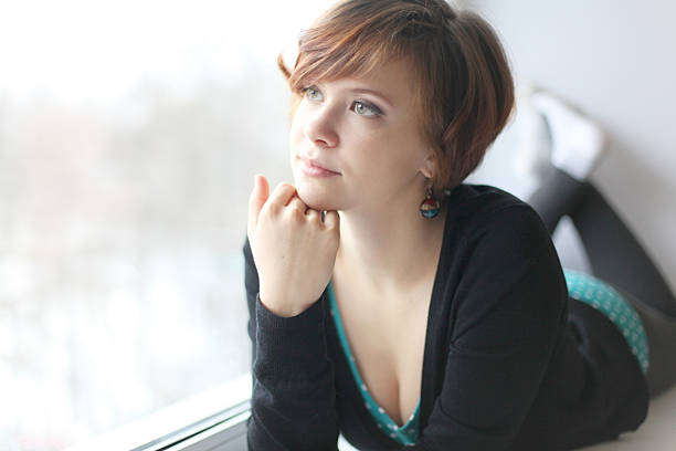 fun sexy girl lying on the windowsill