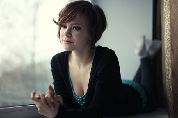 fun sexy girl lying on the windowsill