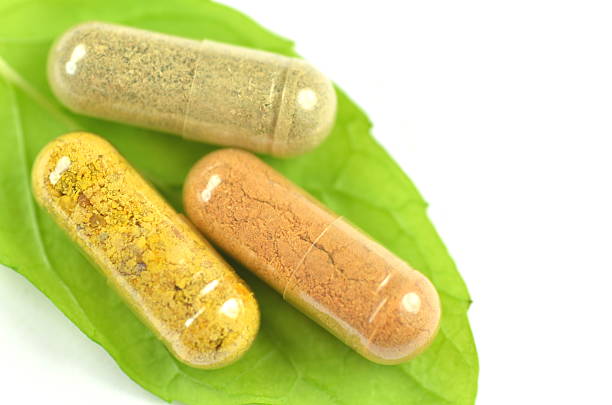istock closeup of herbal capsules on melissa leaf isolated on white 467171500