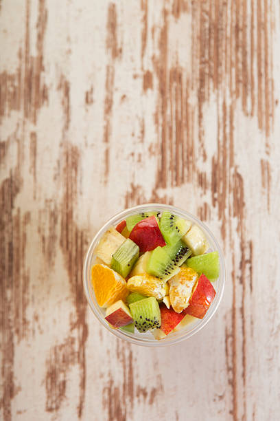 Fruit salad to go Fresh chopped fruits in a plastic cup ready to serve,top view strawberry crush stock pictures, royalty-free photos & images