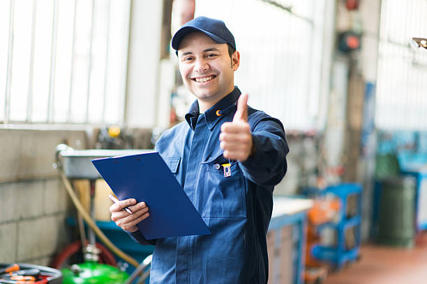 Smiling mechanic thumbs up stock photo