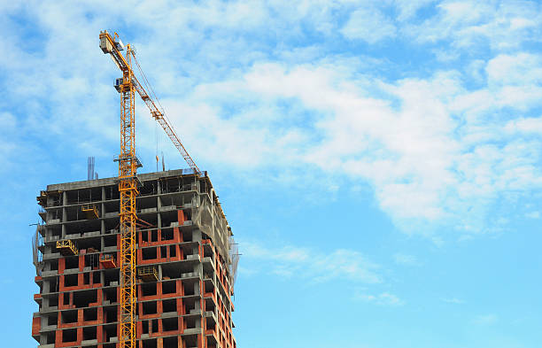 istock Building crane under construction site against blue sky background 467176942