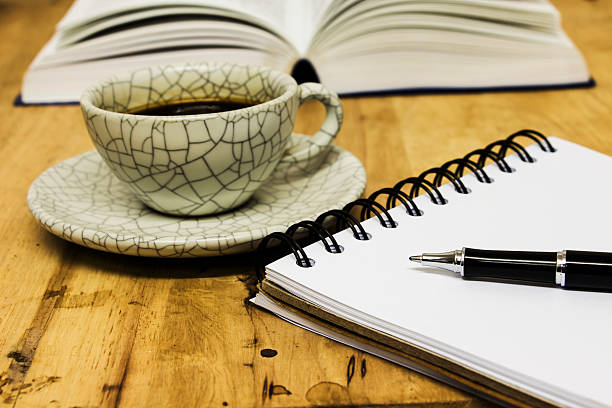 istock notebook,pen,cup of coffee and  crackers on the desk 467177247