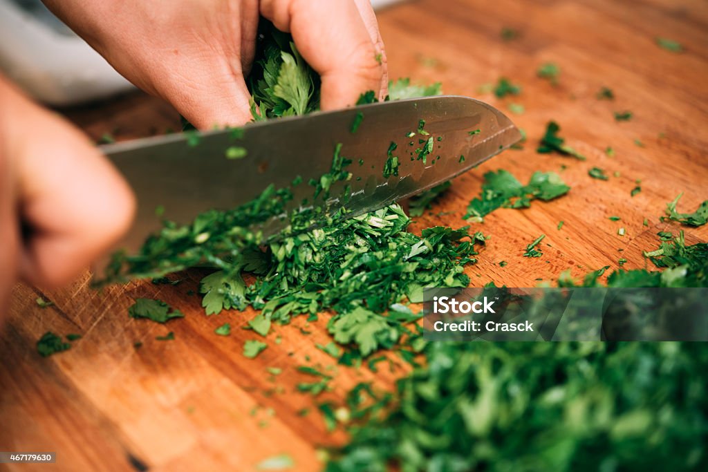 Cutting parsley in a kitchen. Chef Stock Photo