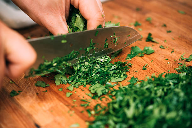Cutting parsley in a kitchen. Cutting parsley in a kitchen. penknife stock pictures, royalty-free photos & images