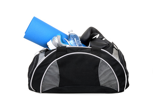 gym bag with shoes yoga mat and water bottle isolated on white background