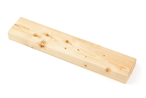 An 18 inch long piece of 2×4 lumber, isolated on a white background. This is the common type of pine lumber used for home construction and also in many other projects. Shot in studio with a Canon 5D Mark II DSLR camera.
