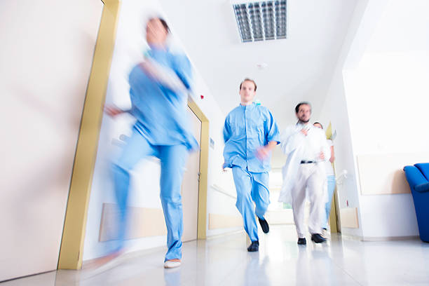 istock Doctors and nurses rushes for emergency in hospital corridor 467182511