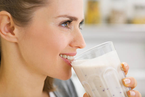 Happy young woman drinking cocktail
