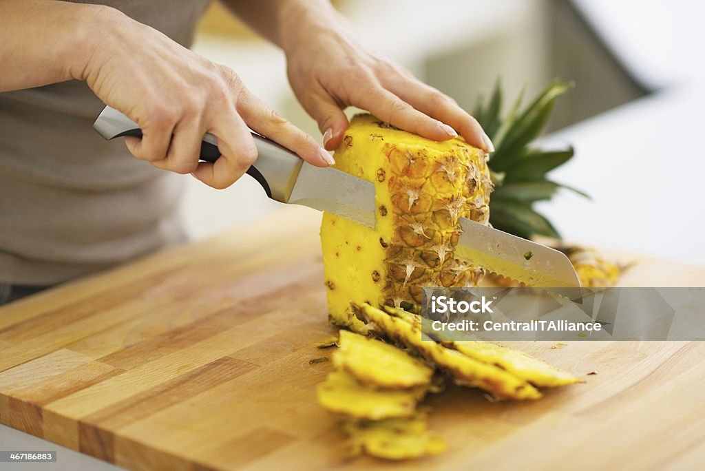 closeup on woman cutting pineapple Closeup on woman cutting pineapple Pineapple Stock Photo