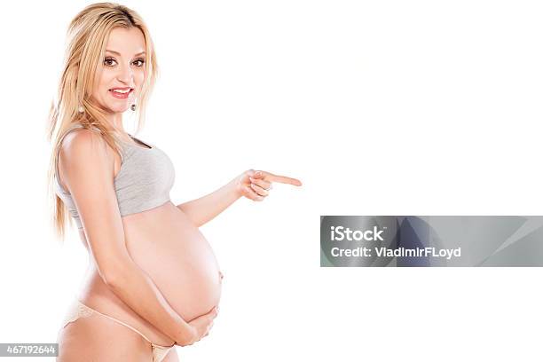 Pregnant Woman Showing Direction With Her Finger Stock Photo - Download Image Now - 2015, Abdomen, Adult