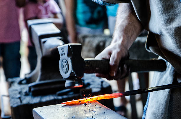 istock Blacksmith working red hot metal an anvil and hammer 467193845