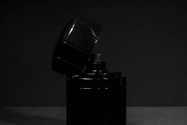istock Small bottle of aftershave on black background 467194021