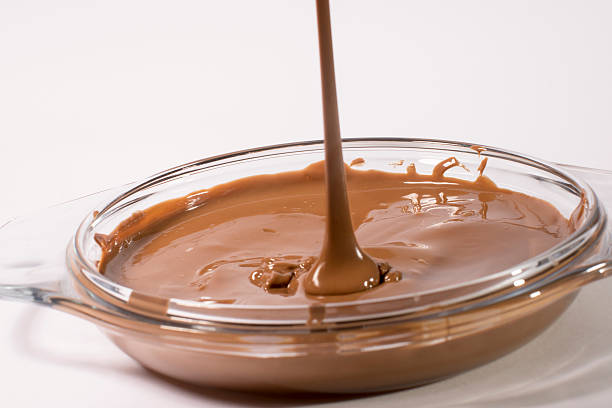 istock Glass bowl of melted milk chocolate 467194215