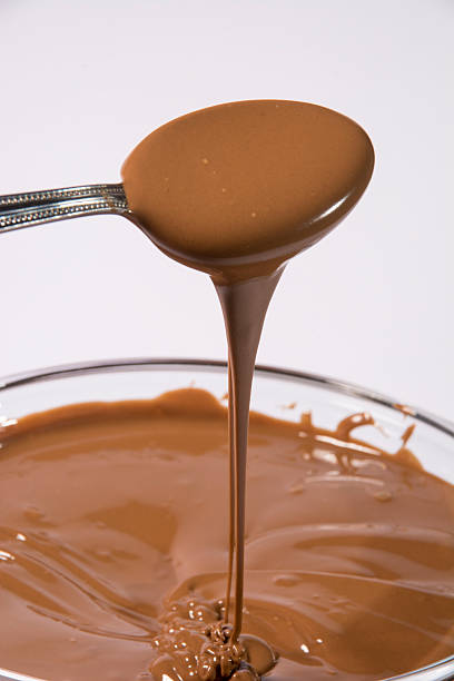 istock Glass bowl of melted milk chocolate 467194285