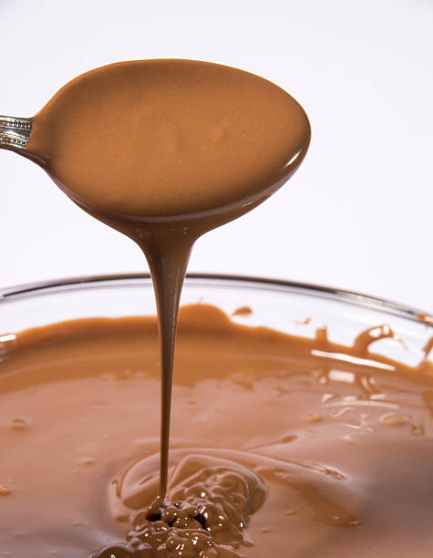 istock Glass bowl of melted milk chocolate 467194291