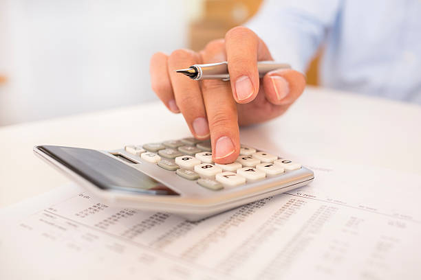 istock A close-up of a man doing accounting work on a calculator 467194599